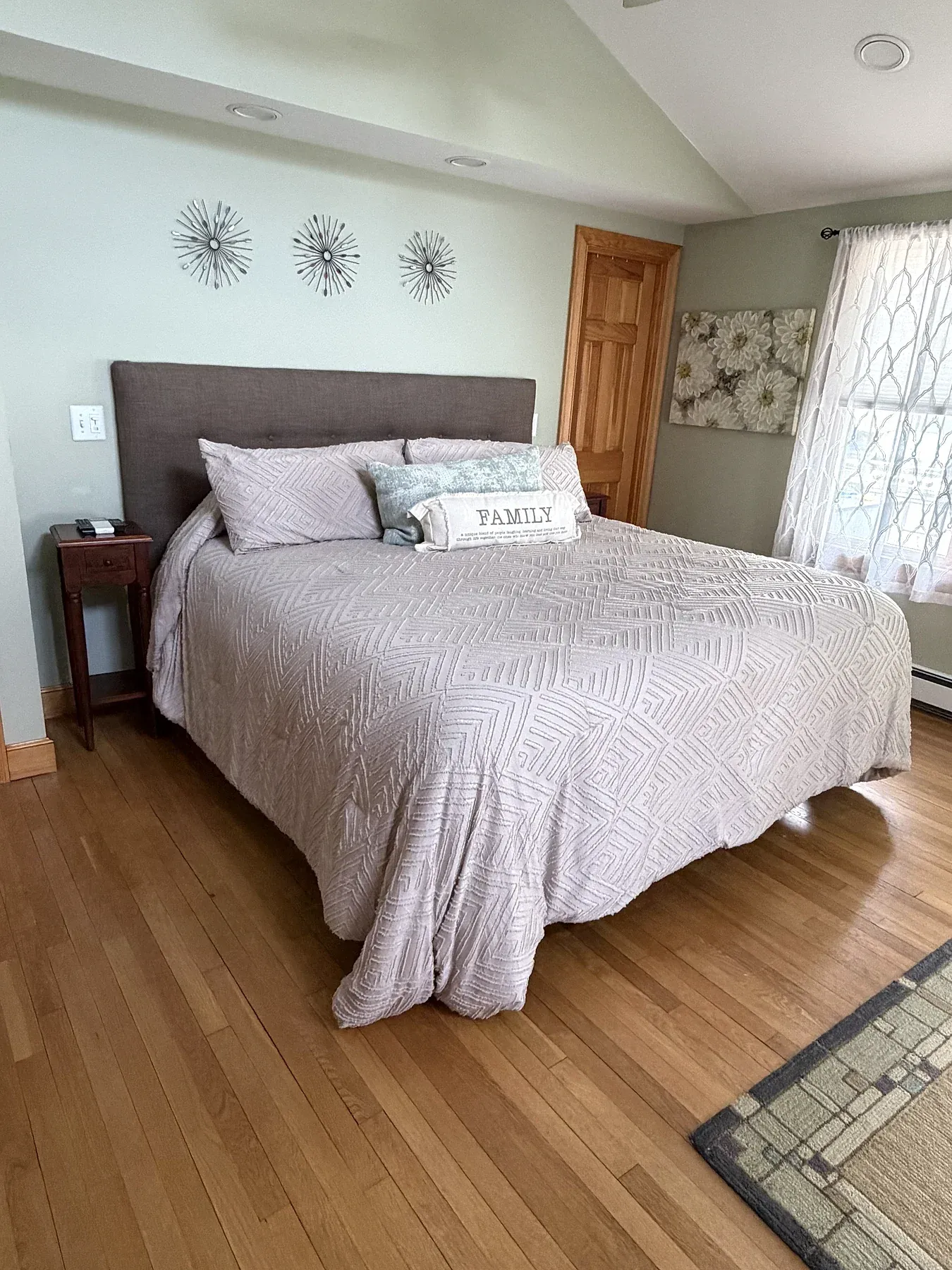 A guest bedroom made with clean bedding and bedside tables ready for arrival.