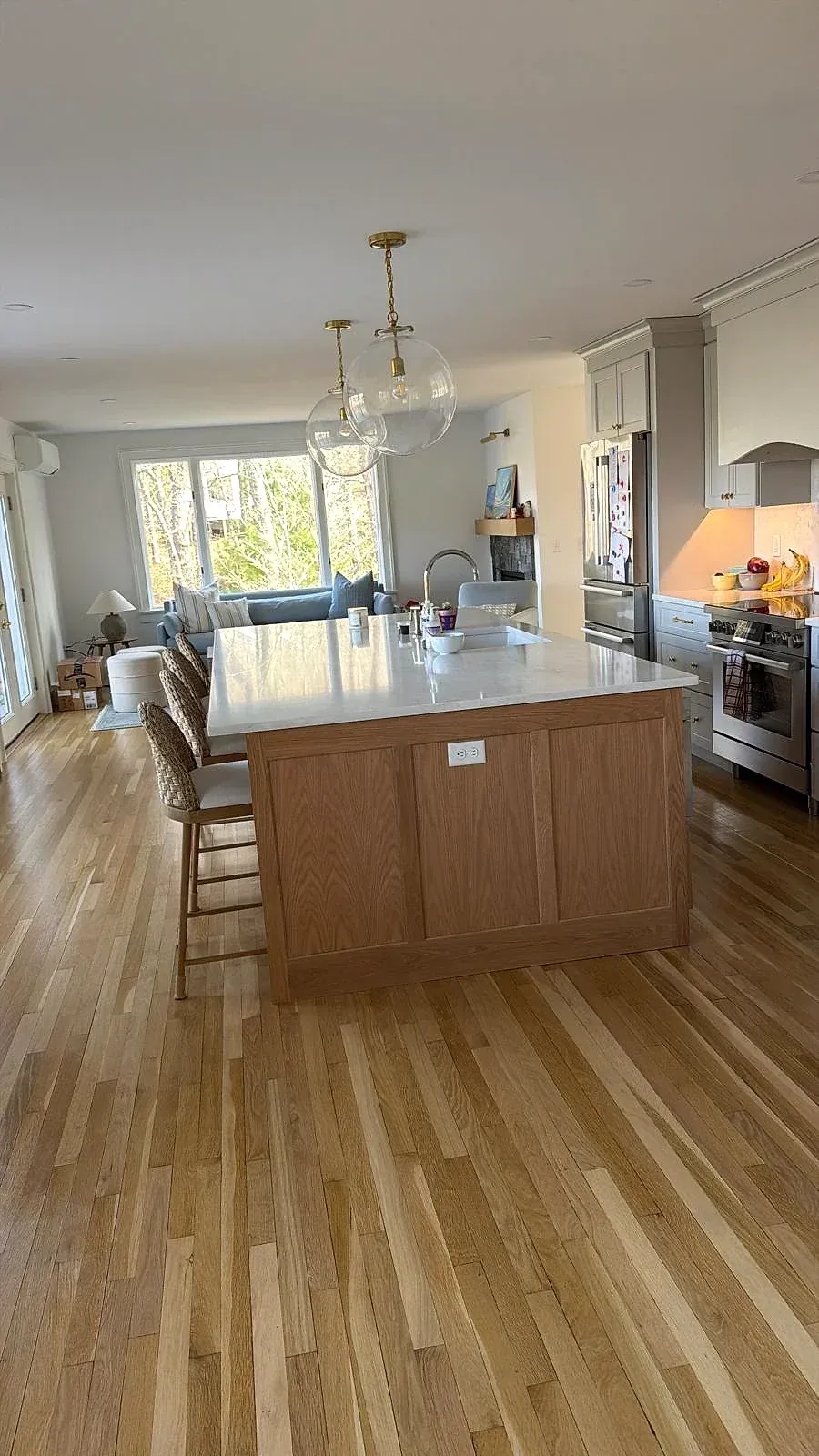 A clean residential kitchen with appliances, counters and floors in order.